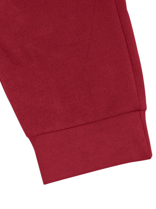 Close-up view of red long sleeved vintage trousers from Kakaclo showcasing soft fabric and cuff details