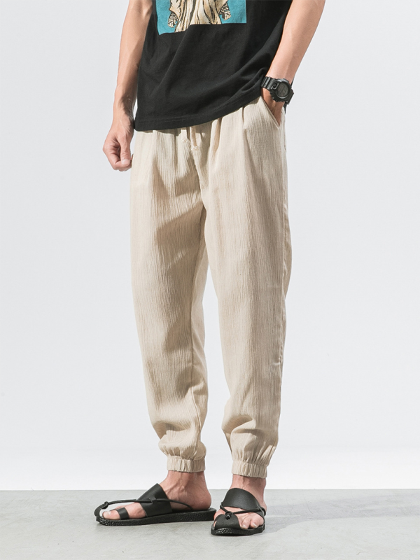 Men's linen drawstring pants in light beige with an elastic hem for a comfortable fit