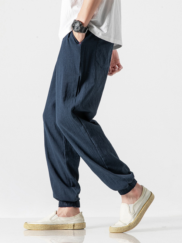 Men's linen drawstring pants in navy blue with a relaxed fit and elastic cuffs