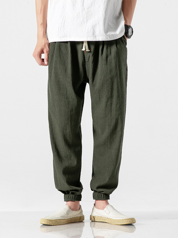Men's linen drawstring pants in olive green, featuring a relaxed fit and elastic cuffs for comfort