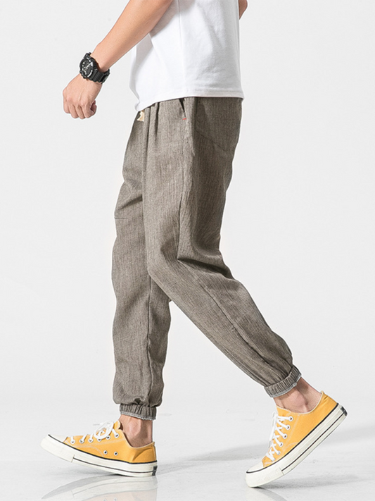 Men's linen drawstring pants in light brown with elastic cuffs for casual comfort and style