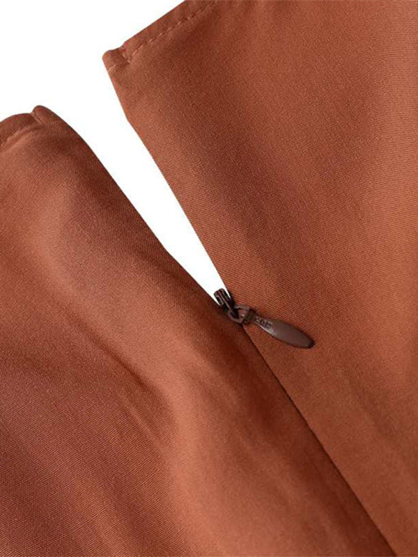 Close-up of the zipper detail on a kakaclo vintage swing dress in a rich brown color